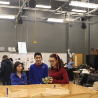 Two high school students looking at a robotics project.